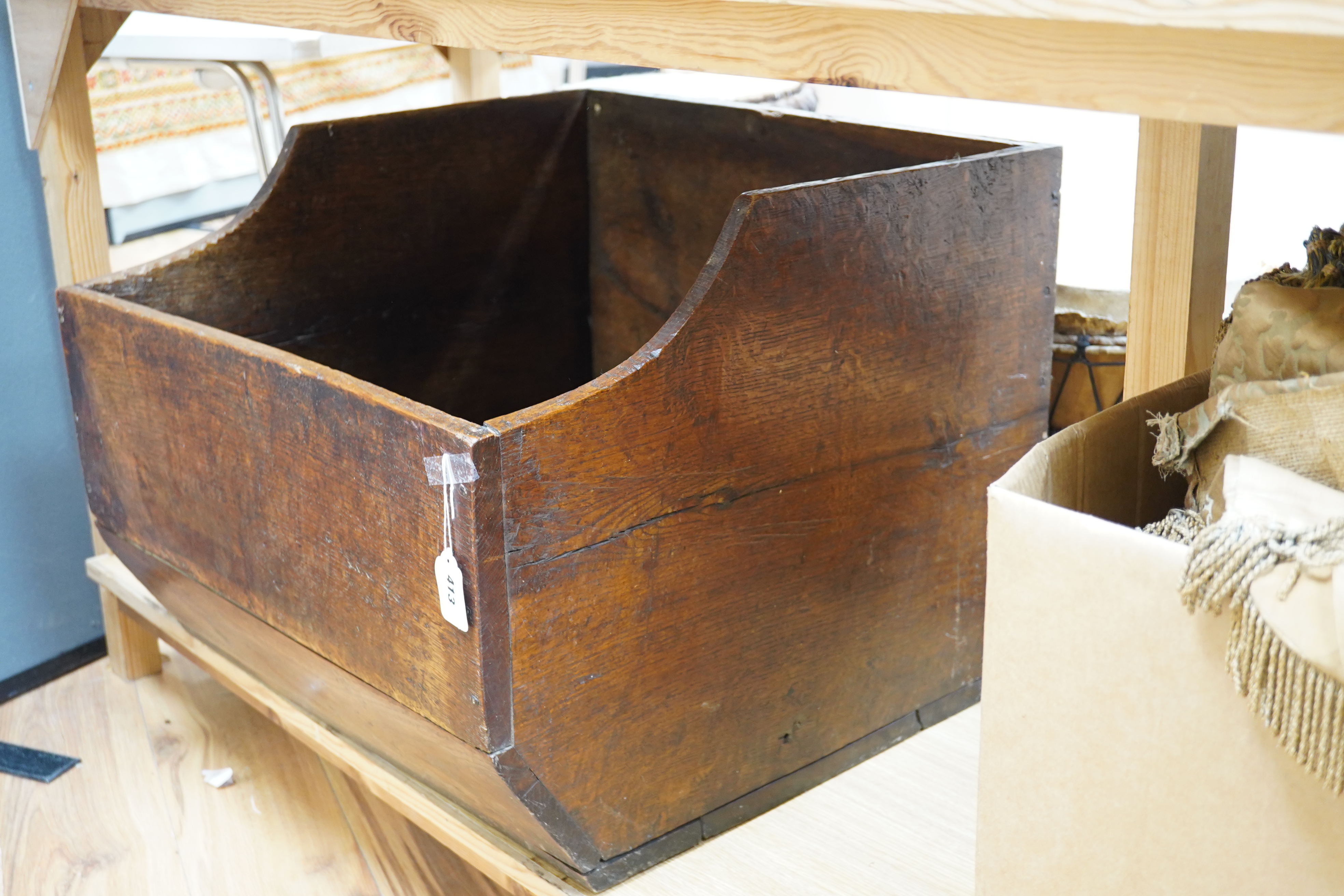 An early 20th century oak dog basket, 65cm wide. Condition - fair